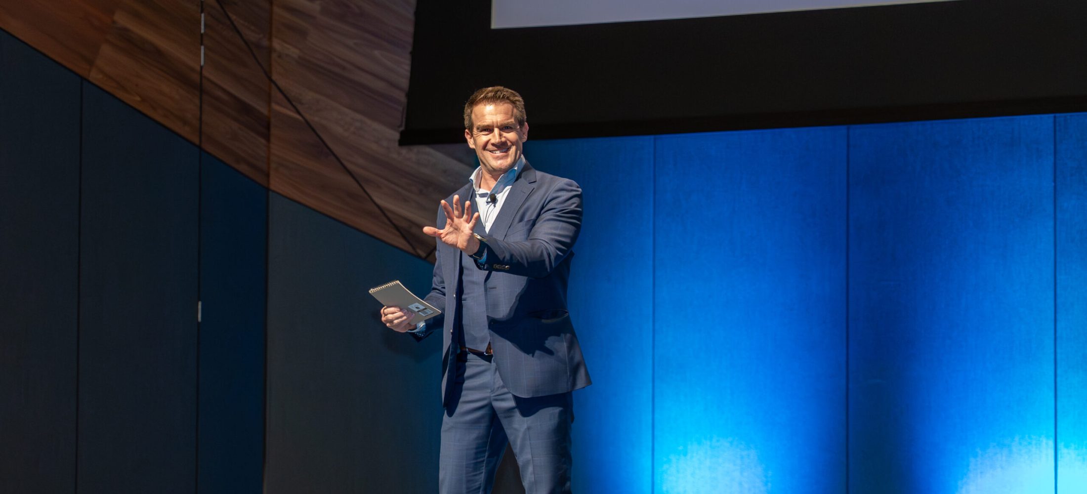 Photographer capturing a candid moment of a key speaker at a corporate event.